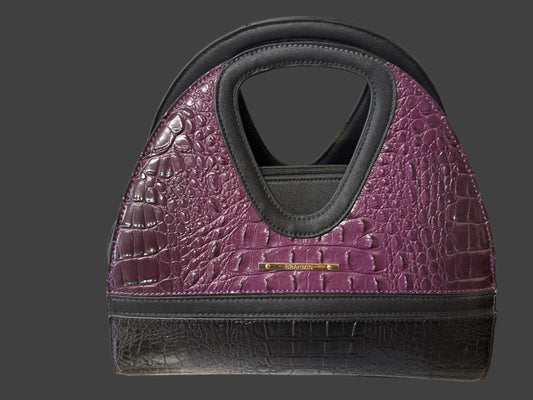 Purple textured handbag with black accents on a white background