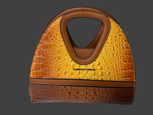Two-tone handbag with brown and yellow crocodile texture on a white and green background